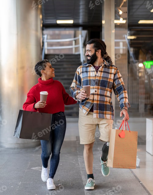 Preview: Happy couple carrying shopping bags and enjoying christmas time together