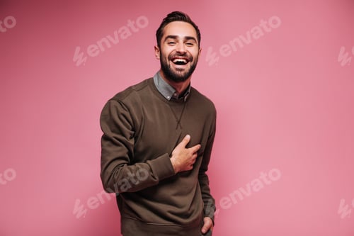 Preview: Guy in brown sweater laughs wholeheartedly against isolated background.