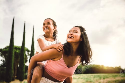 Preview: Asian mother and daughter having fun outside