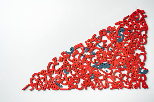 Preview: Top View image of a group of Arabic letters made of wood, colored red and blue on a white background