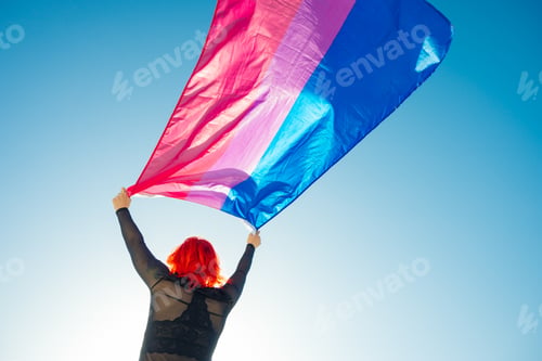 Preview: Beautiful low angle shot of a female waving red and blue flag