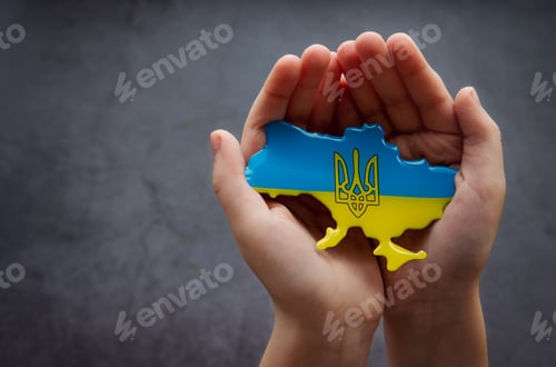 Preview: Hands holding the shape of Ukraine border with color flag. Stand with Ukraine