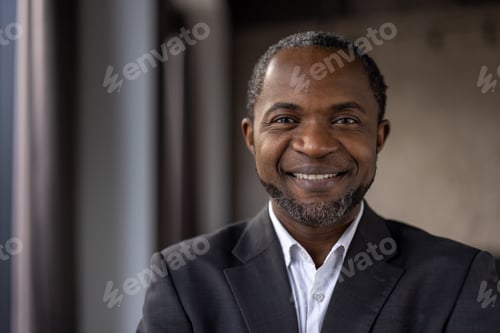 Preview: Confident african american businessman smiling in office environment
