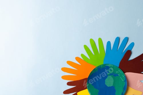 Preview: Paper cut out of multi coloured hands and globe with copy space on blue background