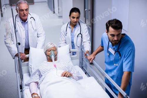 Preview: Doctor and nurse pushing emergency stretcher bed in corridor