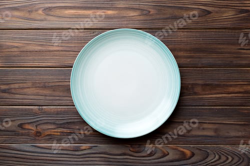 Preview: Top view of empty blue plate on wooden background. Empty space for your design