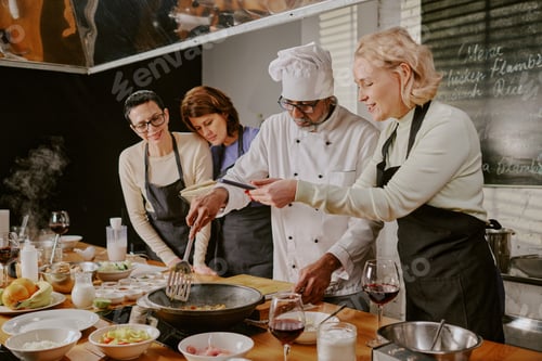 Preview: Diverse Group of Adults Participating in Cooking Class with Chef Instructor