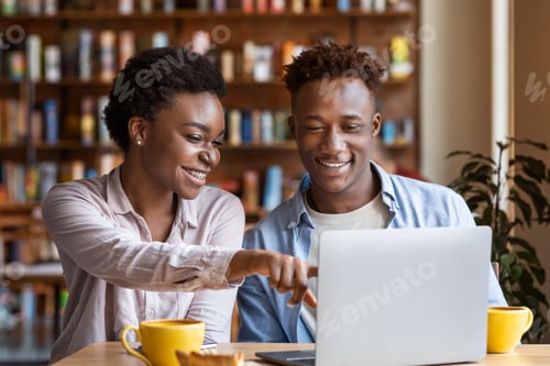 Preview: Black lady with boyfriend watching movies on laptop at cafe
