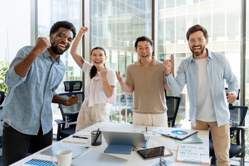 Preview: Overjoyed business team celebrating success in modern office
