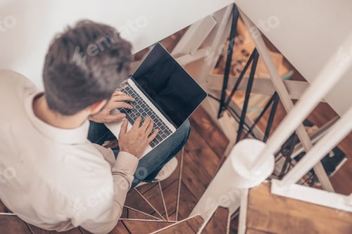 Preview: Working young businessman with laptop