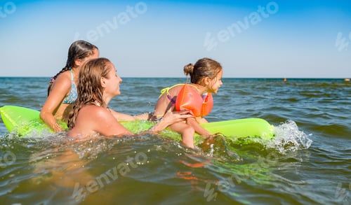 Preview: Happy mother and two small positive daughters