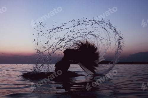 Preview: The woman twists her long hair