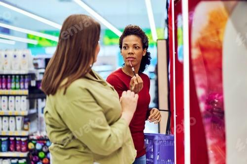 Preview: A pretty African woman shopping in a beauty section with her female friend.