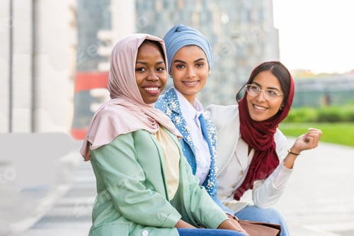 Preview: Beautiful muslim girl wearing hijab bonding outdoors
