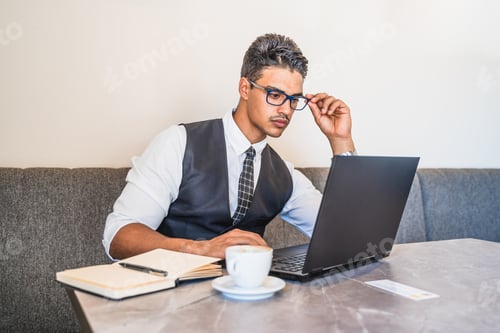 Preview: Man Working on Laptop at Coffee Shop