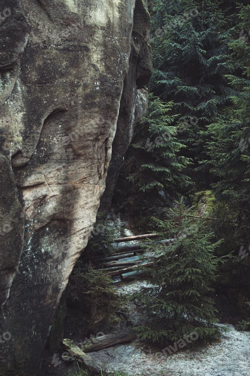 Preview: Towering Rock Formation in Lush Green Forest - Natural Wonder