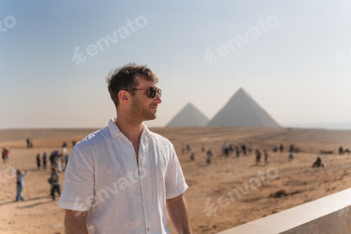 Preview: Tourist admiring giza pyramids in egypt on sunny day