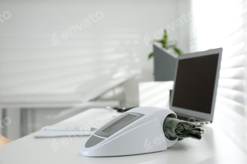 Preview: Digital blood pressure monitor on table in doctor's office