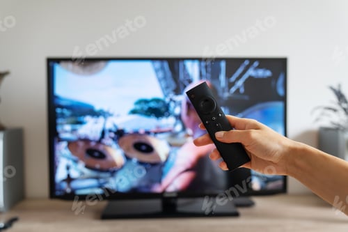 Preview: A woman's hand holds a TV remote control. Shot point of view. Rest after a working day, watching a