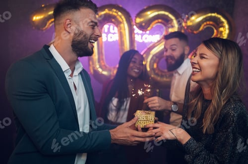 Preview: Happy beautiful couple celebrate New Year's Eve and exchanging gifts