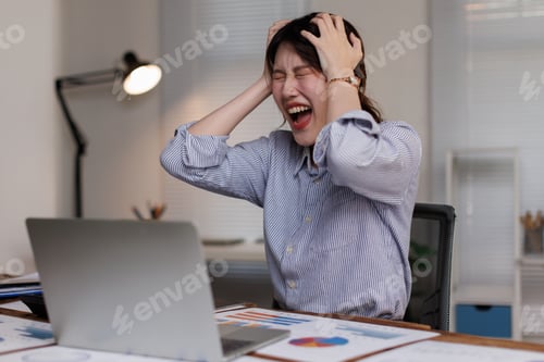 Preview: Young Asian Businesswoman Suffering from Neck Pain While Working on Laptop at Office Desk