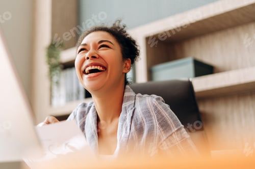 Preview: Happy entrepreneur enjoying success while working at office desk