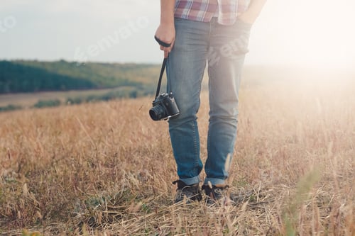 Preview: Attractive male photographer outdoors at sunset