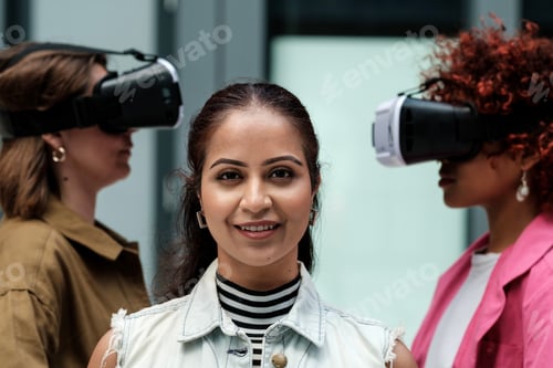 Preview: Businesswomen experiencing virtual reality with vr headsets