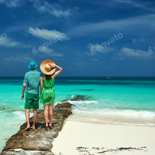 Preview: Couple In Green On A Tropical Beach At Maldives
