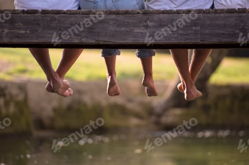 Preview: people sitting at wooden bridge