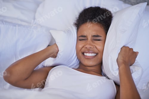 Preview: Nothing is going to make me get up today. Cropped shot of a restless young woman lying in bed.