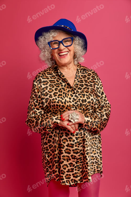 Preview: Vertical studio shot of attractive happy ederly woman wears hat, shirt with leopard print and tights