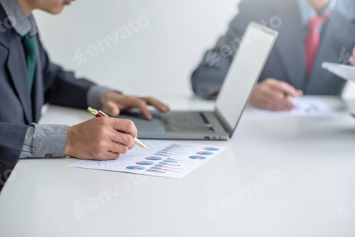 Preview: Business people meeting analyzing financial documents at meeting.