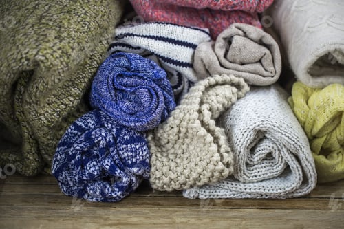 Preview: Sweaters on wooden background