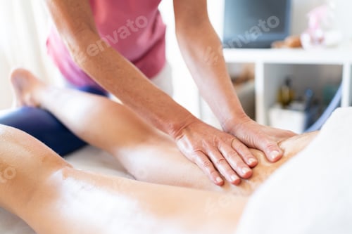 Preview: Crop masseuse rubbing oily skin of client during body massage in clinic