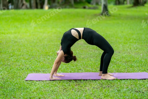 Preview: A woman is doing a yoga pose in a park