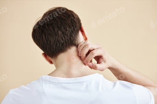 Preview: Back view of man scratching neck rash or skin condition