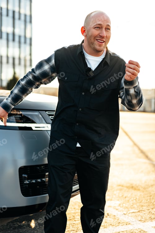 Preview: Casual man standing near his luxury car at the parking
