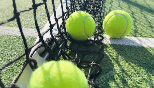 Preview: Bright greenish, yellow tennis ball on freshly painted court