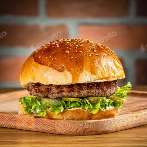 Preview: Veal burger with cheddar cheese, onions and mushrooms on a wooden floor