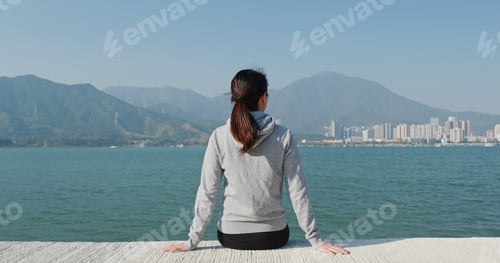 Preview: Woman enjoy the sea view at pier dock