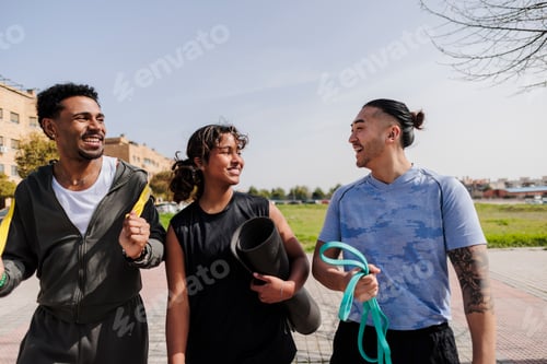 Preview: Diverse friends walking outdoors carrying fitness gear