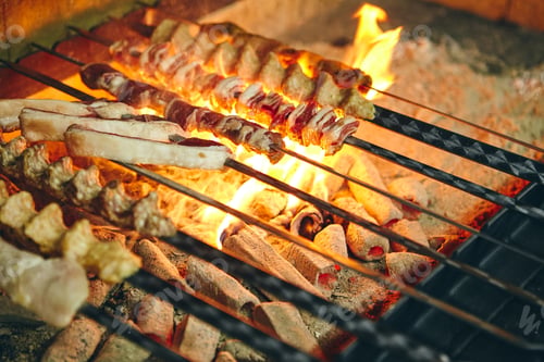 Preview: Shish kebab on skewers from different types of meat is fried on the grill