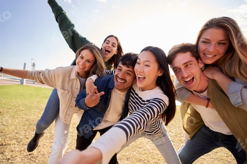 Preview: Young people smiling and posing in a field under a cloudy sky