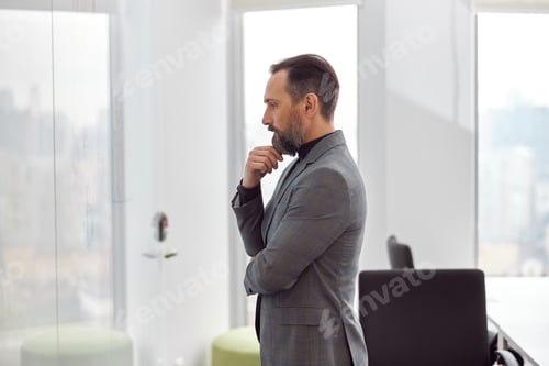 Preview: Caucasian adult man in office is writing on the glass desk