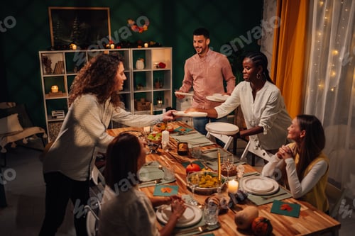 Preview: Friends serving food at thanksgiving dinner table