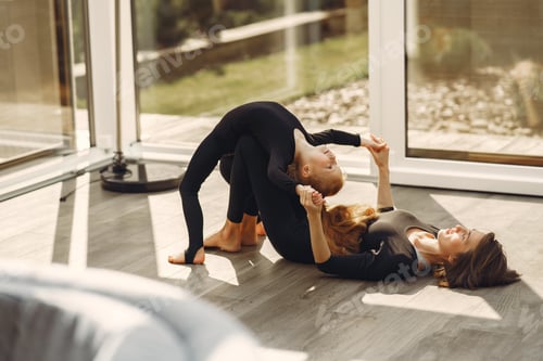 Preview: Woman with daughter is engaged in gymnastics
