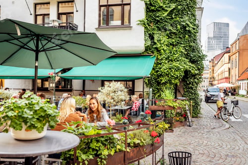 Preview: Two female friends relaxing in outdoor cafe