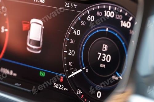 Preview: Dashboard display shows fuel and distance metrics in a car at noon