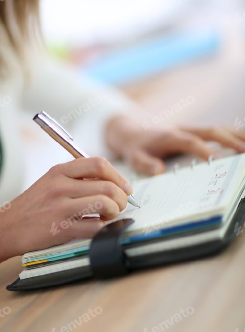 Preview: Closeup Of Woman'S Hand Writing On Agenda